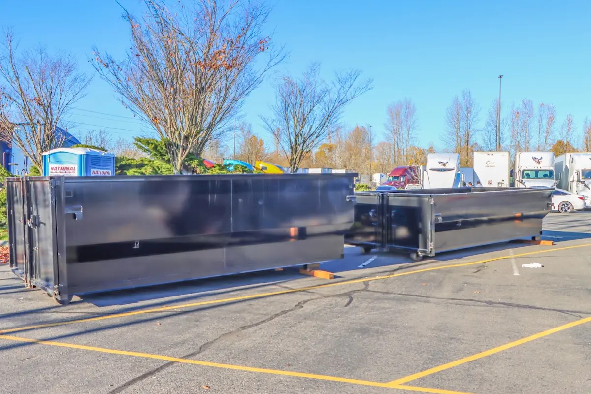 Professional dumpster rental service with roll-off container on residential driveway in St. Peter